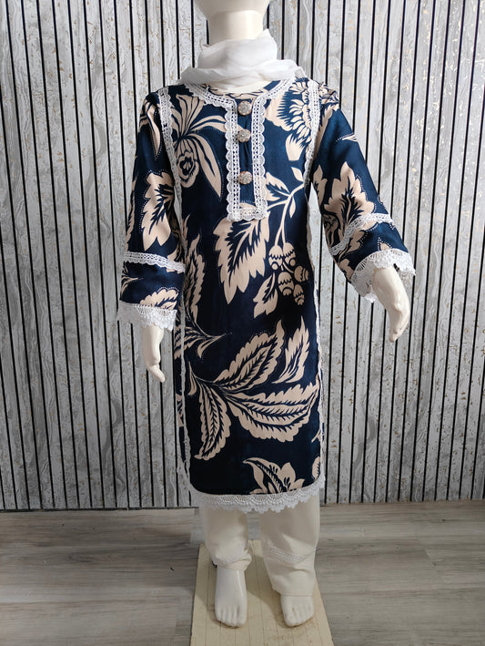 Mannequin wearing a navy blue and white floral dress with lace details against a striped wall.